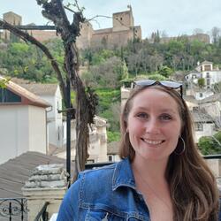 A picture of Elizabeth in front of the Alhambra in Granada, Spain.