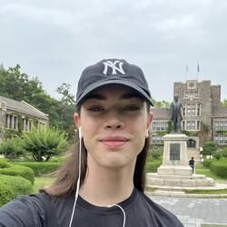 selfie of author wearing black hat and black t shirt in front of yonsei 