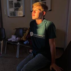 Young boy wearing "Experiment Exchange" t-shirt