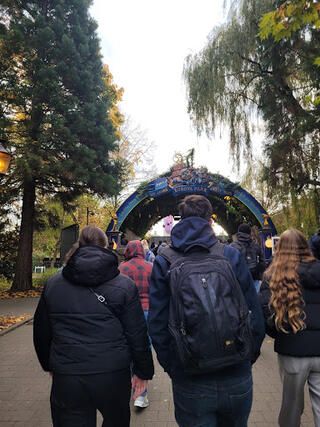 Thomas and his host family walk through the festive entryway into the park.