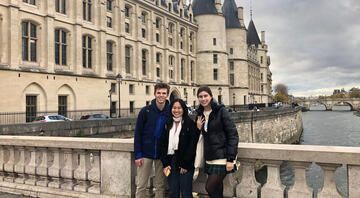 Gap year students group photo beside castle in Paris