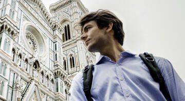 Florence man with backpack in front of cathedral