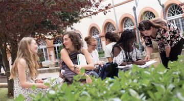 High school students conversing in garden at CIEE Center in Toulouse