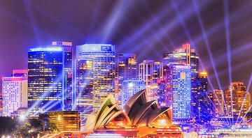 sydney opera house at night with spotlights