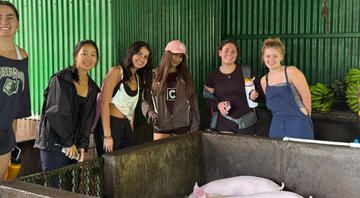monteverde-students-campus-tour-farm-pigs