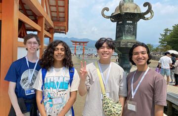 Kyoto students standing outside torii gate on Miyajima Island