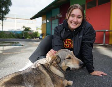 Jordyn here pictured with one of the dogs that hangs out at her Internship Site 
