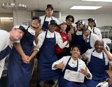 Lungelo K., at bottom right, poses with his coworkers at the Sea Island Company in Georgia. The South African native served as a CIEE BridgeUSA Trainee.