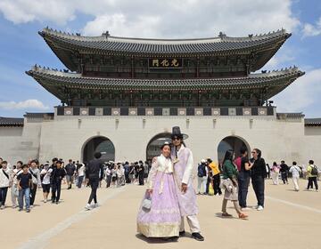 Infront Gyeongbokgung Palace with matching Hanboks