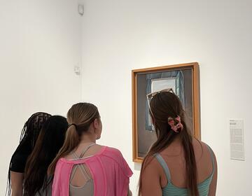 Students looking at art in museum