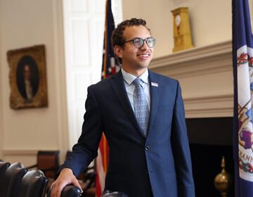 gregory perryman standing in a suit in a university office building