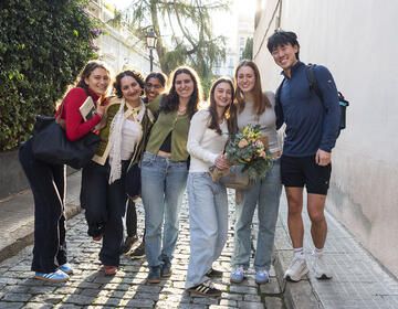 Students smiling in a group on street while studying abroad