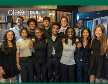 12 students stand together smiling with "CIEE Dublin" in white text in the top left corner