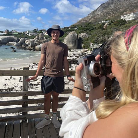 students take photos of each other abroad cape town