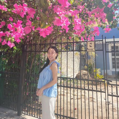 yucatan female student pink flowers outside