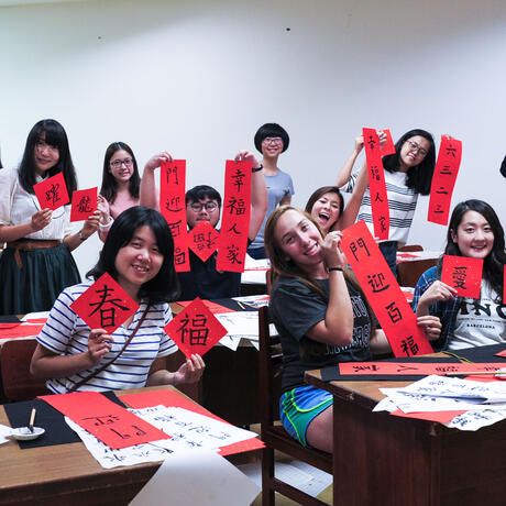 taipei students showing off their calligraphy scrolls