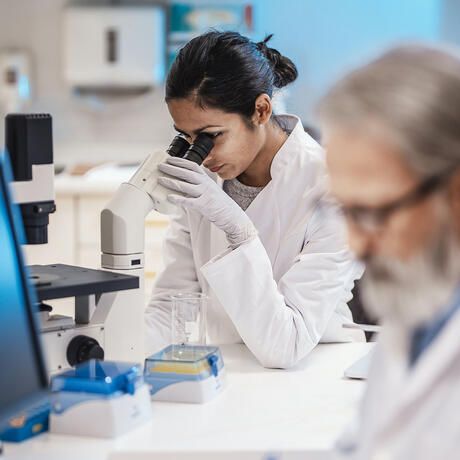 intern-woman-using-microscope-lab