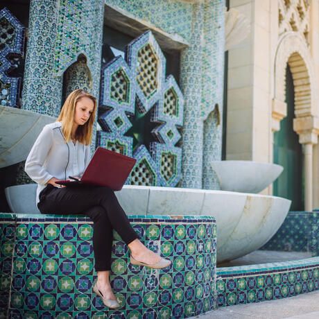 seville-girl-intern-sitting-outside-laptop