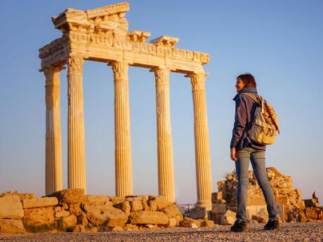 athens-student-backpack-standing-before-column-ruins