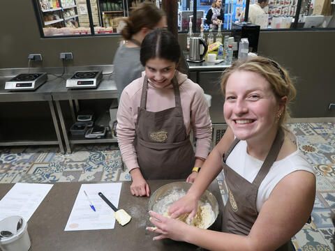 High school abroad students smiling in pastry workshop 