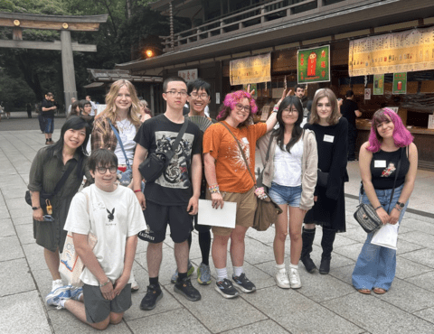 students posing with their stamps at a shrine