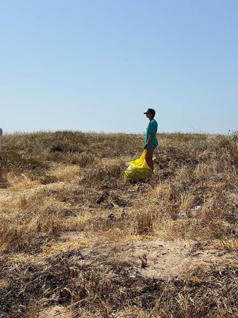 high school student cleaning up beach in Lisbon
