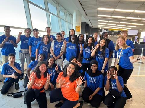 Group of teens posing at the airport before studying abroad
