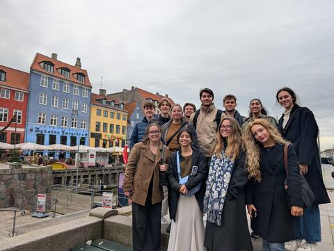 College first year abroad students posing before canal tour excursion in Amsterdam