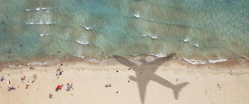 airplane shadow on beach abroad