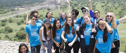 High schoolers wearing Global Navigators shirts smiling in Mexico