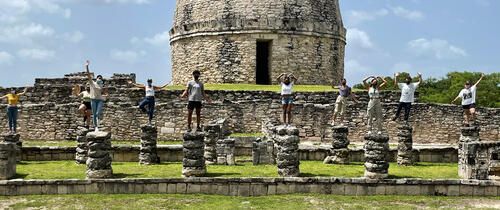 yucatan students standing ruins