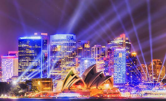 sydney opera house at night with spotlights