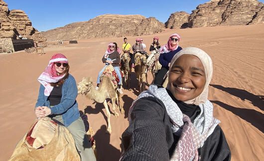 students ride camels abroad amman jordan