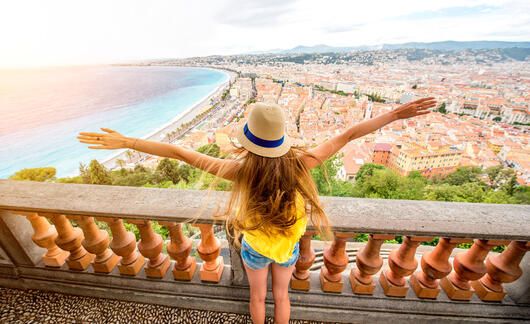 nice-woman-outstretched-arms-overlooking-city-wide