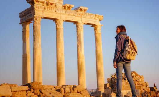 athens-student-backpack-standing-before-column-ruins