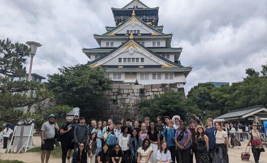 Students pose in front of temple during overnight trip