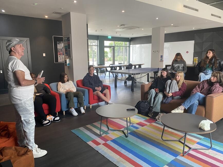 Students listen to Glenn Gannon talk about his experience. 
