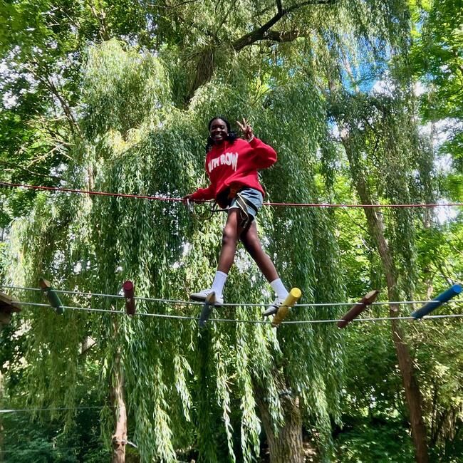 A student crossing one of the rope bridges. 