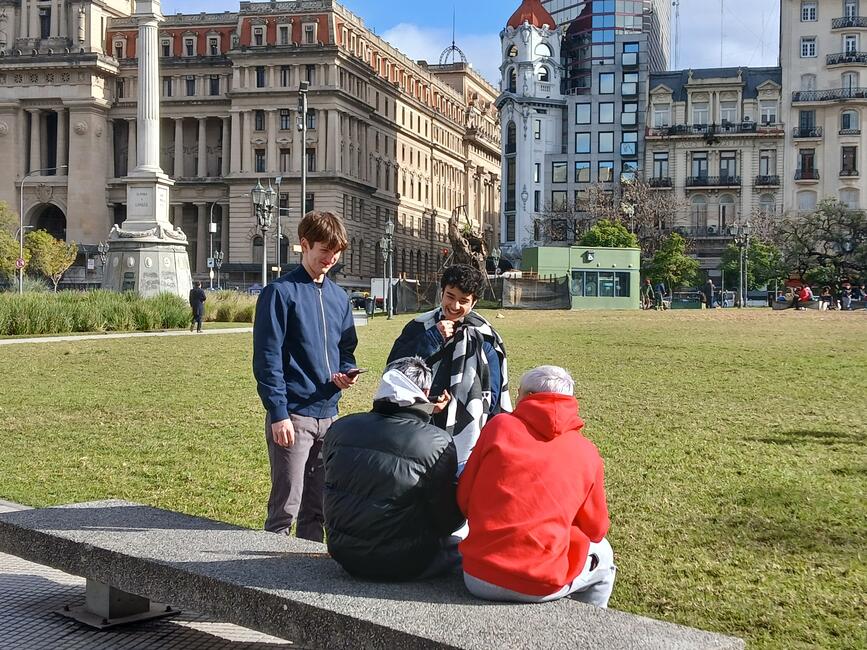 Students having a conversation in a local plaza