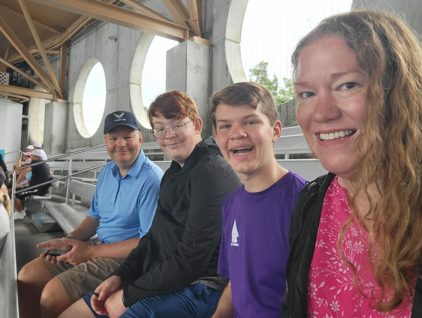 A Smiling Family Sits in a Seaworld Arena
