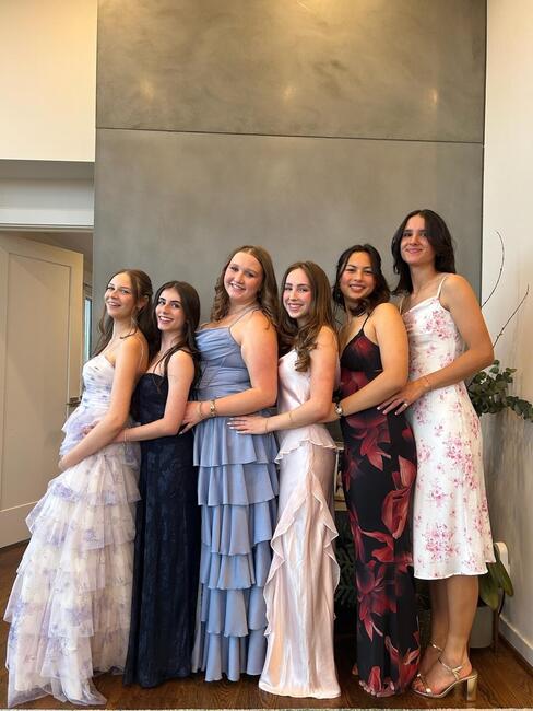Izzy M. poses with friends in their formalwear.
