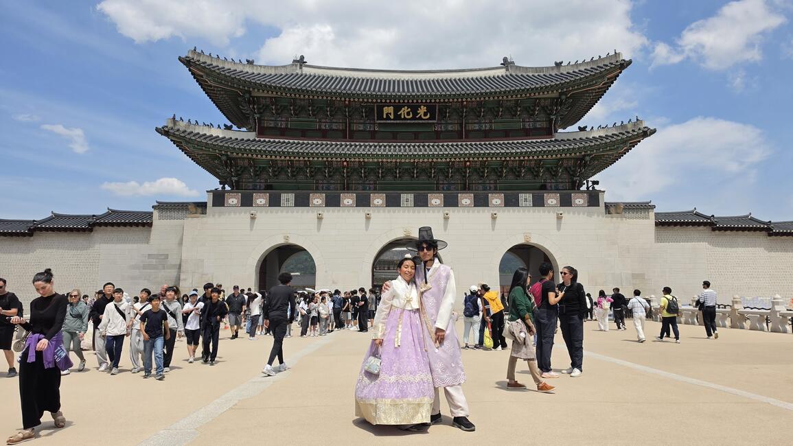 Infront Gyeongbokgung Palace with matching Hanboks