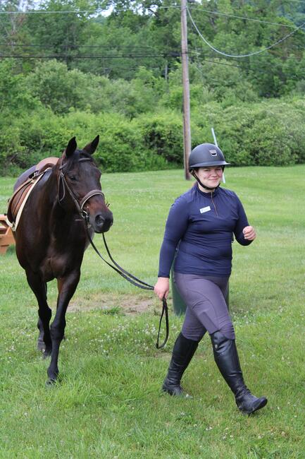 Venla S. of Finland leads a horse at a summer camp in Connecticut.