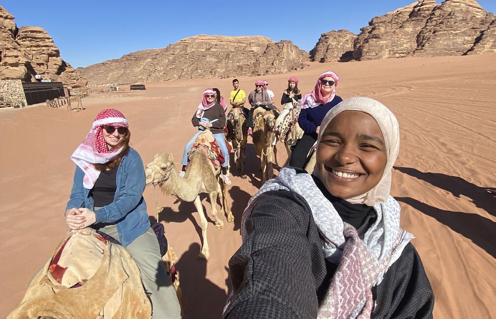 students ride camels abroad amman jordan