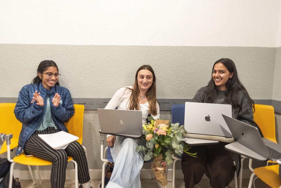 Students abroad in classroom with laptops