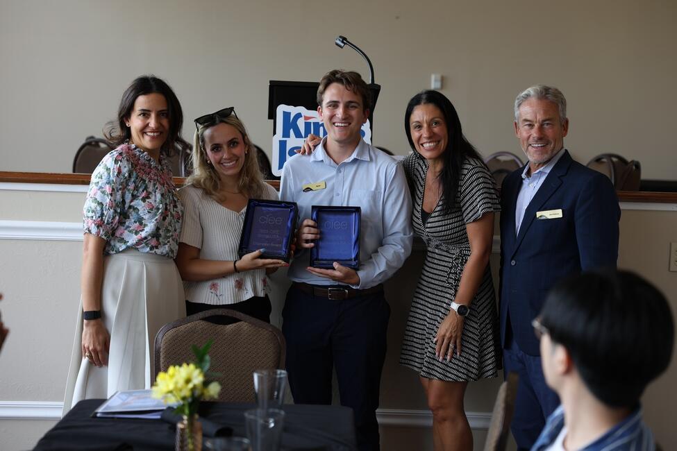 a group of people accepting an award