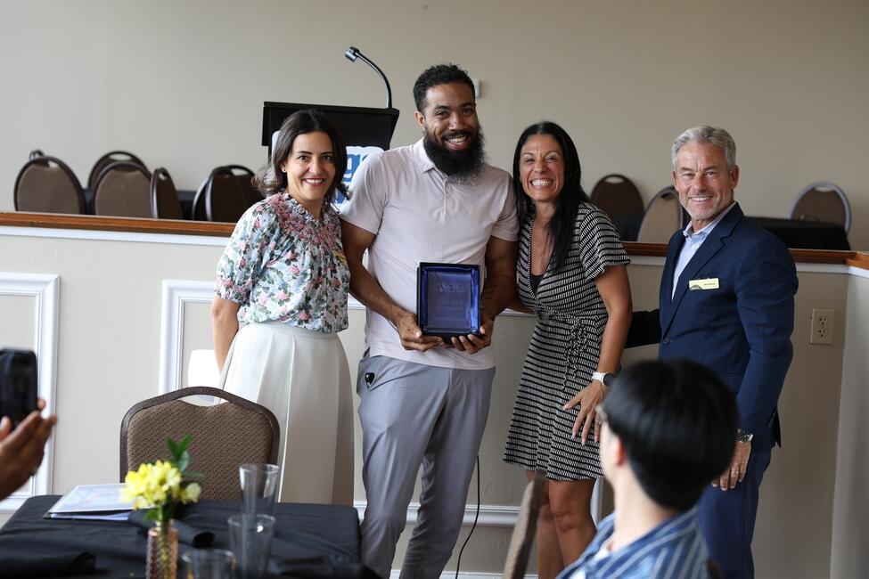 a group of people accepting an award