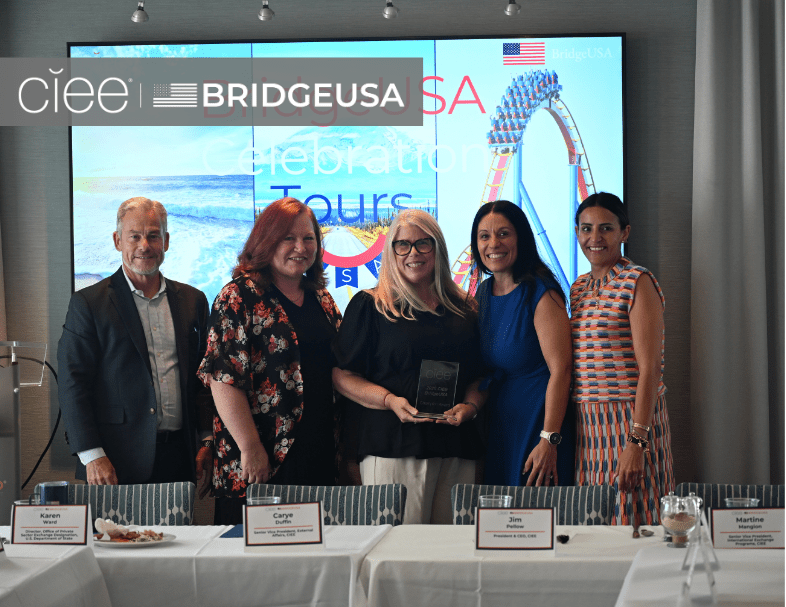 CIEE and BridgeUSA representatives pose with an award recipient during a BridgeUSA Celebration Tour event
