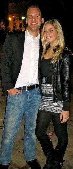 a man and a woman standing side by side smiling, the photo is from 2010