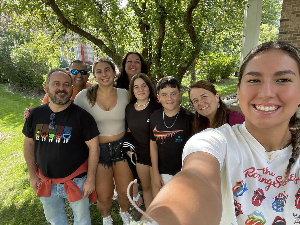 High school student posing with host family in Seville, Spain